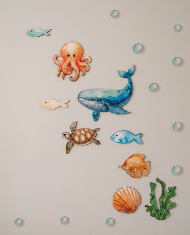 Ocean wooden wall art set arranged as a quiet cove — The octopus and shell clustered in a calm little corner.