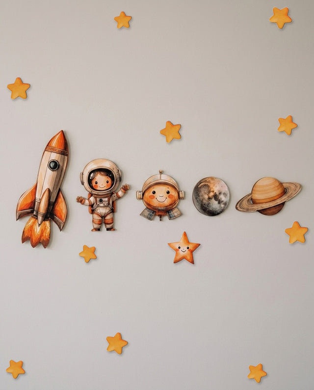 Space wooden wall art set arranged as in orbit — The pieces circle a shelf or ledge, drifting like planets around a sun.