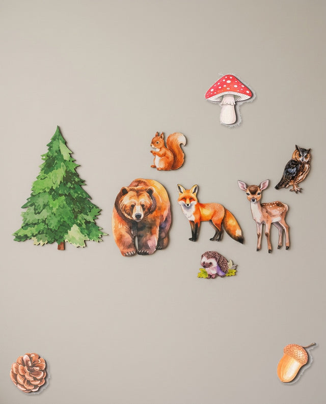Woodland wooden wall art set arranged as along the path — The animals lined across a shelf like a forest trail.